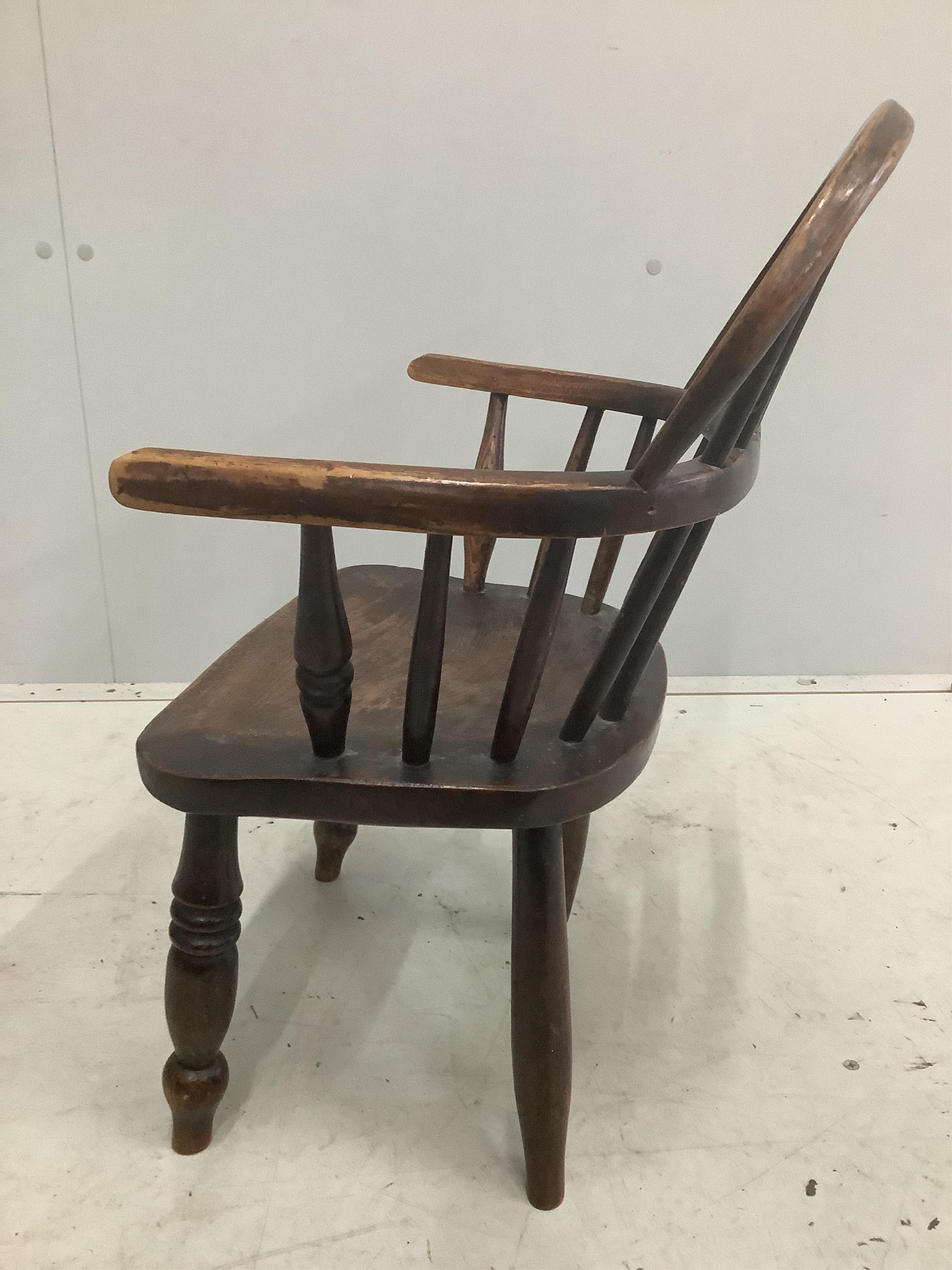 A Victorian ash and elm Windsor child's elbow chair, width 43cm, depth 28cm, height 60cm. Condition - fair